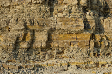 The abstract shapes, patterns and textures of the limestone surface appear to be layered.Natural pattern and texture background. Copy space.Limestone wall on the edge of the lake. For graphic design 