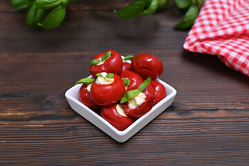 Italian appetizer mini peppers antpasti on the table close-up