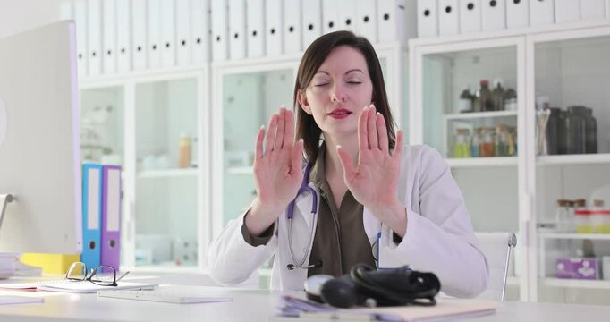 Young woman physician shakes head expressing disagreement with boss. Professional doctor shows disagreement with patient during consultation slow motion