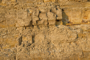 Abstract patterns, shapes and textures of natural cracks on the limestone surface.Natural pattern and texture background. Copy space..For graphic design or banner background.Limestone wall on the edge