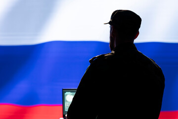 Ex KGB FSB secret police agent using mass propaganda technology tools on laptop to influence...