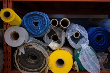 Colorful Fabric Rolls on Shelf