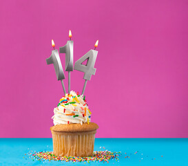 Cupcake with birthday candle number 114 - Anniversary card on blue and violet background