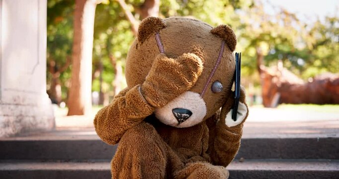 Person, phone call or argument in costume, mistake or angry at missed, casting or audition in park. Bear mascot, tablet or hand gestures to fight, worry or ask question to solve booking problem