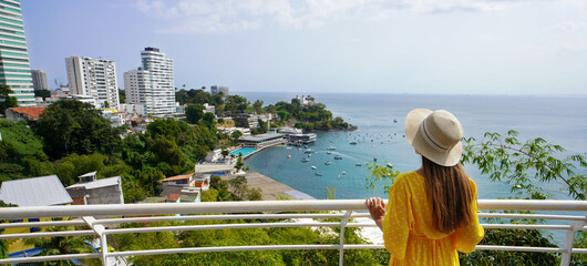 Tourism in Salvador de Bahia, Brazil. Beautiful fashion girl enjoying view from Mirante da Vitoria...