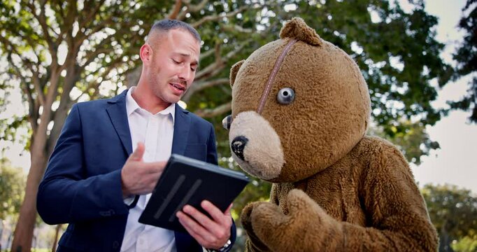 Business people, tablet and team planning outdoor at park in funny teddy bear costume. Technology, meeting and collaboration of consultants in brainstorming discussion, mistake or fail with mascot
