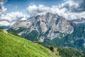 Marmolada mountain range towering over green valley, Dolomites, Italy