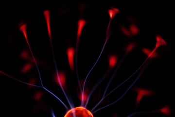A glowing plasma ball with red and blue energy arcs radiating against a dark background, creating a vivid and electrifying visual effect