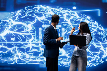 IT department coworkers solving tasks on laptop and tablet, running artificial intelligence...