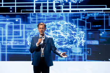 Happy presenter speaking at tech forum, explaining impact of artificial intelligence technology....