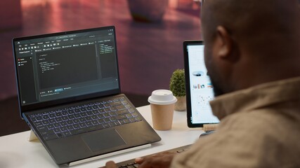 AI software developer creating an algorithm for deep learning and data mining, coding on his laptop...