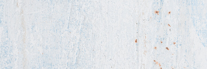 Vintage wall texture. The weathered, rough surface of a plastered concrete wall with faded, peeling paint. Perfect for background and design. Closeup. High resolution.