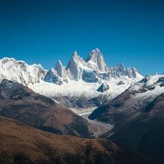 Majestic mountain range with snow-capped peaks under a clear sky