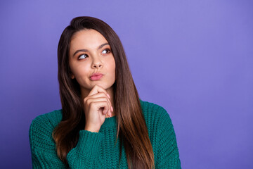 Portrait of pretty young girl look empty space ponder wear sweater isolated on violet color...
