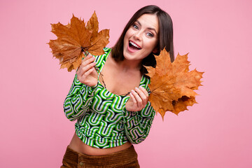 Photo of positive adorable woman wear green trendy clothes hold bouquet dry leaves isolated on pink...