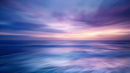 Obraz premium A mesmerizing view of a vibrant and colorful sunset over the ocean, with smooth waves blending into a dreamy purple and pink sky, capturing tranquility and peace.