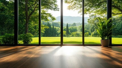 Bright room with large windows showcasing lush green landscape outside.
