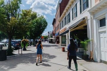 Pedestrians on foot path and shops on Nassau St in downtown Princeton, New Jersey, United States.
