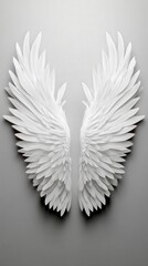 Fototapeta premium White angel wings on a gray background, perfect for creative projects.