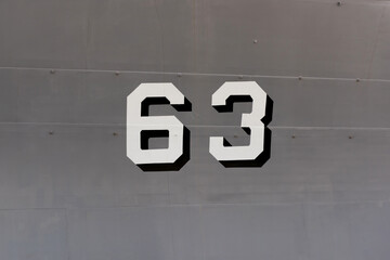 Number 63 on iron wall of battleship