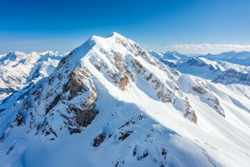 Fototapeta premium The mountain is covered in snow and has a rocky peak