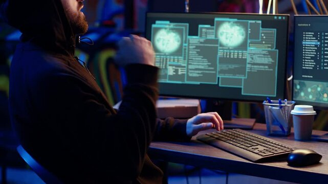 Hacker hiding in underground bunker excited after developing zero day exploit undetectable by antivirus. Malicious man successfully tricks firewalls, celebrating accomplishment, camera B close up