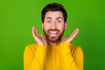 Photo of impressed man with stylish beard dressed yellow shirt raising palms on face astonished...