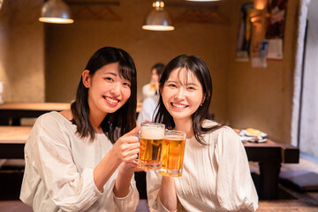 居酒屋で女子会をする二人の女性