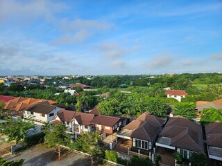 Suburban Houses with Lush Greenery and Blue Sky
