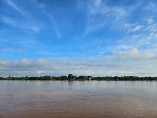River Landscape with Blue Sky and White Clouds