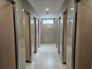 Modern Public Toilet Stalls with Grey Tiles and Window