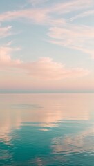 Fototapeta premium serene, peaceful sea, with still, mirror-like, turquoise water reflecting a warm, soft, pastel-hued sky at sunrise or sunset,