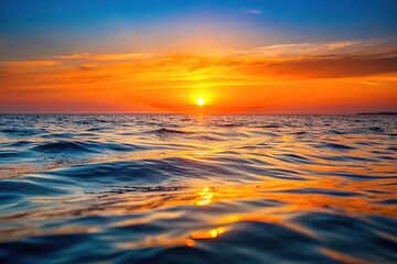 Obraz premium Seascape orange sunset over the sea with sun setting, creating depth of field effect
