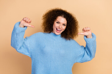 Photo of young positive funny successful girl in blue knitted sweater pointing fingers at herself...
