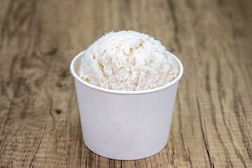 Round scoop of white sticky rice in a bowl to eat