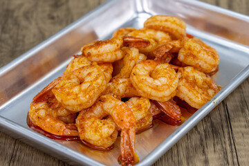 Tempting appetizer tray of peeled shrimp seasoned in cajun flavoring