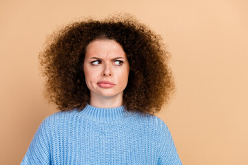 Photo portrait of lovely young lady look suspicious empty space dressed stylish blue knitwear...