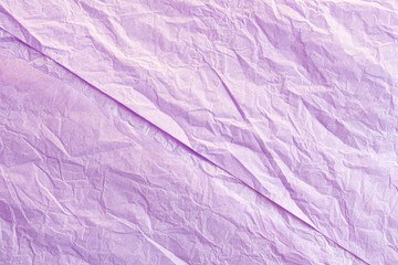 An abstract image of the crinkled texture of a sheet of purple tissue paper. 
