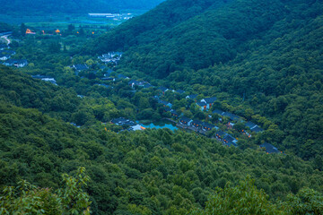 Fototapeta premium Shaoxing, Zhejiang Province - High angle view of trees and buildings at night