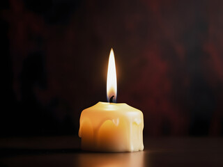 single burning candle in the dark background	