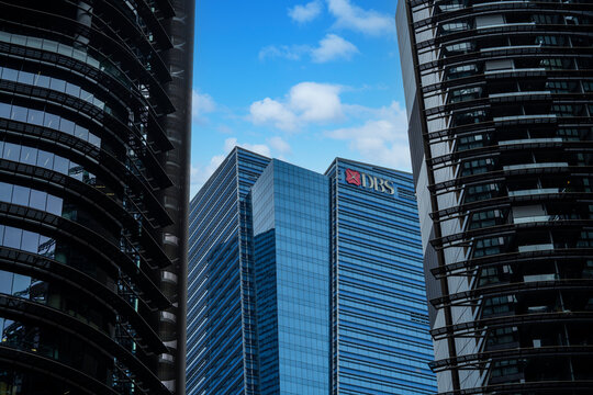 Singapore &ndash; October 2024. The DBS logo atop of the DBS financial building at Marina Bay framed between the towers of the adjacent Marina Bay One building.