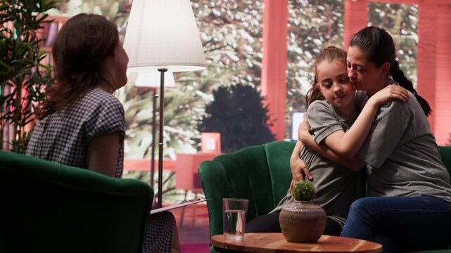 Warm loving mother showing unconditional love for her daughter, showing compassion and sharing a hug at therapy. Mom accepting her girl with hormonal shifts, family relations. Camera A.