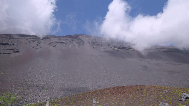 Clouds are rapidly moving across the sky above the Hoei Crater on Mt.Fuji. 4k 10bit footage