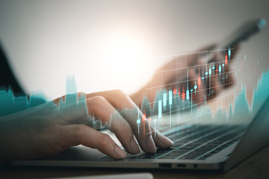 Business using laptop and mobile phont with exponential arrow and financial graph for business investment growth. Financial, data analysis, goal,success and money concept.