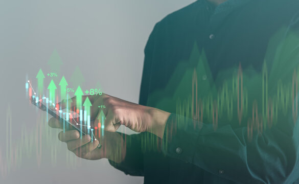 Business using mobile phont with exponential arrow and financial graph for business investment growth. Financial, data analysis, goal,success and money concept.
