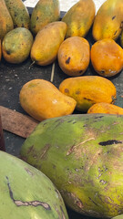 Colorful table brimming with fresh, cold mangoes ready to enjoy at Holbox Beach, Mexico, sold by local vendors. A perfect representation of tropical flavors, beach life, and refreshing summer treats