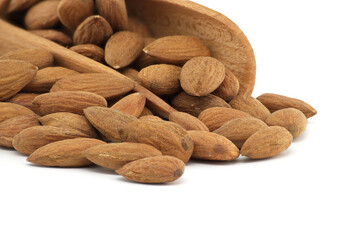 Wooden scoop overflowing with almonds isolated on white background