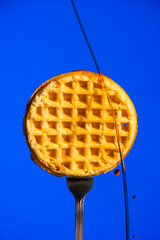 Waffle on Fork with Syrup Dripping Down