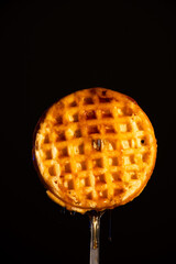 Waffle on Fork with Syrup Dripping Down