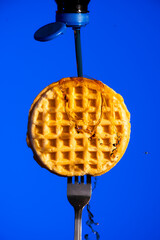 Waffle on Fork with Syrup Dripping Down